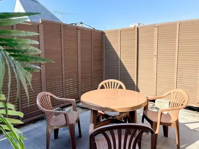a patio with a table and chairs and a fence at SHOGUN Shibuya in Tokyo