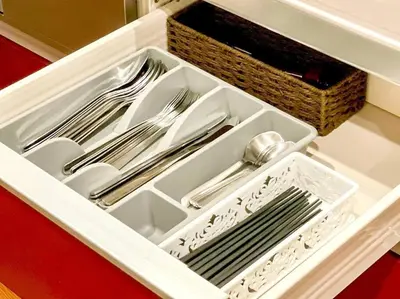 a white drawer with silver utensils in it at SHOGUN Shibuya in Tokyo
