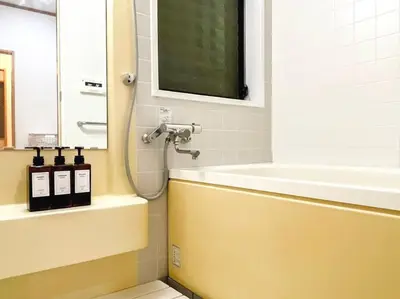 a bathroom with a bath tub and a sink at SHOGUN Shibuya in Tokyo