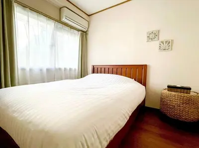 a bedroom with a white bed and a window at SHOGUN Shibuya in Tokyo