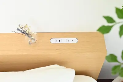 a clock on the head board of a bed at Shinjuku-2minutes Shin-Okubo\u99c5 Very good location in Tokyo