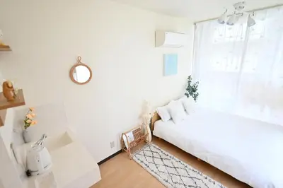 a white bedroom with a bed and a window at Shinjuku-2minutes Shin-Okubo\u99c5 Very good location in Tokyo