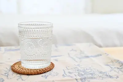 a glass vase sitting on a coaster on a table at Shinjuku-2minutes Shin-Okubo\u99c5 Very good location in Tokyo