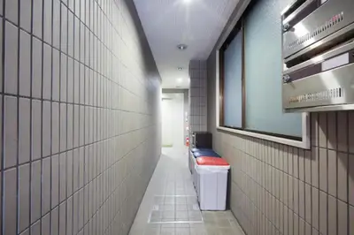 a hallway with a row of toilets in a building at TokyoGuest Akihabara in Tokyo