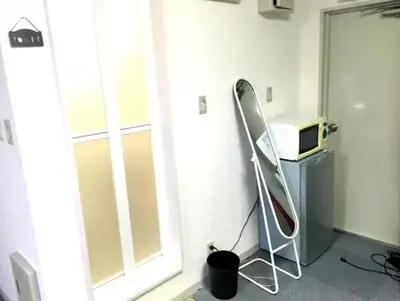 a room with a treadmill next to a window at TokyoGuest Akihabara in Tokyo