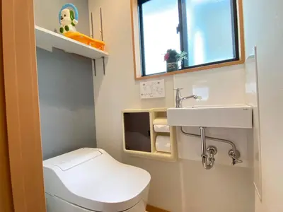 a small bathroom with a toilet and a sink at N9-luxury guest room in Shinjuku in Tokyo