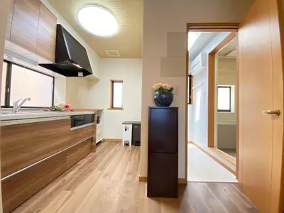 a kitchen with a vase of flowers on a refrigerator at N9-luxury guest room in Shinjuku in Tokyo