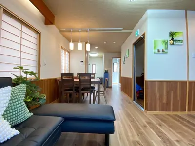 a living room with a couch and a dining room at N9-luxury guest room in Shinjuku in Tokyo