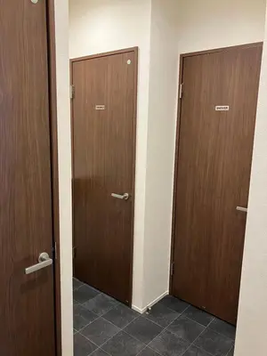 two brown doors in a room with tile floors at Hotel PRELE in Tokyo