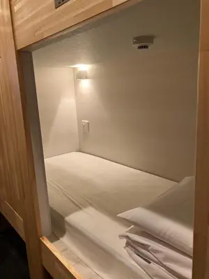 a small room with a bed inside of it at Hotel PRELE in Tokyo