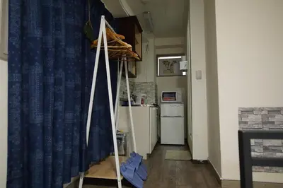 a kitchen with a blue curtain and a refrigerator at TOKYOGUEST\u65e5\u672c\u6a4b in Tokyo