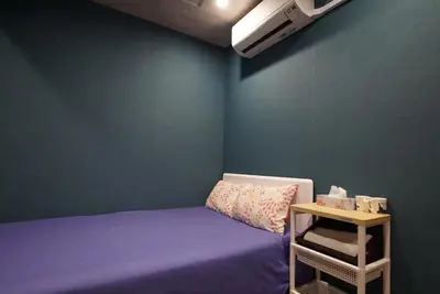 a small bedroom with a bed and a table at TOKYOGUEST\u65e5\u672c\u6a4b in Tokyo