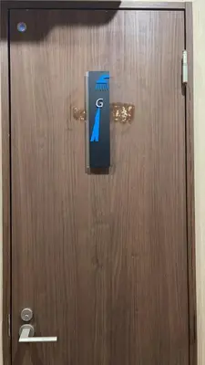 a wooden door with a sign on it at TOKYOGUEST\u65e5\u672c\u6a4b in Tokyo