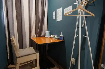a room with a table and a chair and a tripod at TOKYOGUEST\u65e5\u672c\u6a4b in Tokyo