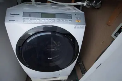 a washing machine is sitting in a room at TOKYOGUEST\u65e5\u672c\u6a4b in Tokyo
