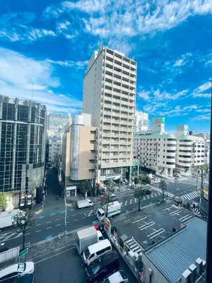 a city with a parking lot and a tall building at Shinjuku-K-SJ0060 in Tokyo