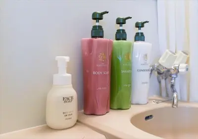 a bathroom counter with four bottles of soap and a sink at Hirojo Building 203,303,403,603,703 - Vacation STAY 15419 in Tokyo