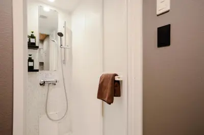 a bathroom with a shower with a glass door at THE BONDS HOTEL TOKYO in Tokyo