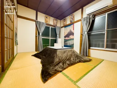 a room with a table with a large pillow on the floor at 7\u6642IN19\u6642OUT # \u6c60\u888b\u738b\u5b50\u8d64\u7fbd\u99c5\u7121\u6599\u9001\u8fce# \u4e0a\u91ce\u99c514\u5206 # \u65e5\u66ae\u91cc\u99c510\u5206 # \u4e00\u68df\u8cb8\u5207 # \u6700\u59277\u540d # B # 7 00 IN19 00 OUT # Free pick up Ikebukuro Oji and Akabane Stations # 14 min to Ueno # 10 min to Nippori # Whole house rental # Max 7 # B in Tokyo