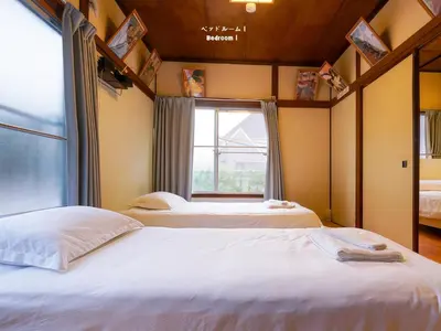 two beds in a room with a window at 7\u6642IN19\u6642OUT # \u6c60\u888b\u738b\u5b50\u8d64\u7fbd\u99c5\u7121\u6599\u9001\u8fce# \u4e0a\u91ce\u99c514\u5206 # \u65e5\u66ae\u91cc\u99c510\u5206 # \u4e00\u68df\u8cb8\u5207 # \u6700\u59277\u540d # B # 7 00 IN19 00 OUT # Free pick up Ikebukuro Oji and Akabane Stations # 14 min to Ueno # 10 min to Nippori # Whole house rental # Max 7 # B in Tokyo