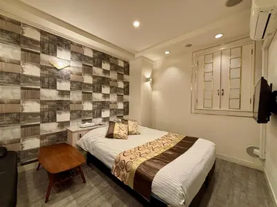 a bedroom with a bed and a desk with a chair at Hotel PRINCESS2 -\u5927\u4eba\u5c02\u7528- in Tokyo