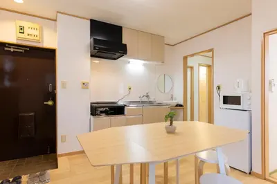 a kitchen with a wooden table and a dining room at Tatekawa 333 Residence - \u7acb\u5ddd\u4e09\u4e09\u4f4f\u5b85- crib free in Tokyo