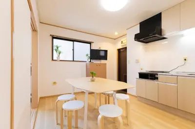 a kitchen and dining room with a table and stools at Tatekawa 333 Residence - \u7acb\u5ddd\u4e09\u4e09\u4f4f\u5b85- crib free in Tokyo