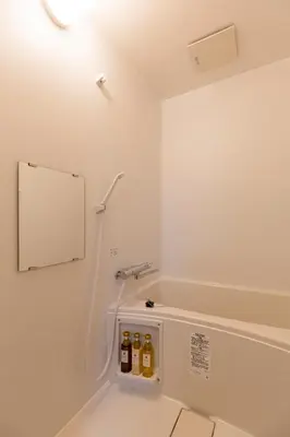 a bathroom with a shower with five bottles of oil at Tatekawa 333 Residence - \u7acb\u5ddd\u4e09\u4e09\u4f4f\u5b85- crib free in Tokyo