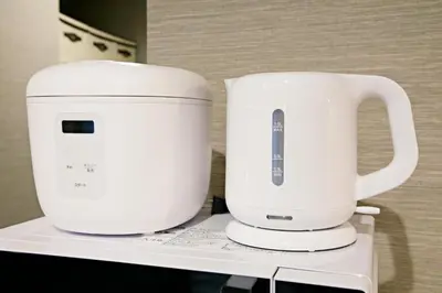 two white coffeemakers sitting on top of a shelf at The Masters Stay SETAGAYA KYODO in Tokyo