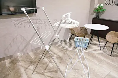 a chair and a table and some chairs and a table at The Masters Stay SETAGAYA KYODO in Tokyo