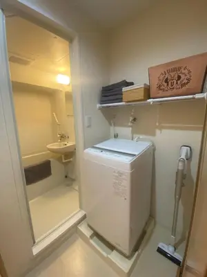 a small bathroom with a toilet and a sink at Mezon Akihabara Guest House in Tokyo