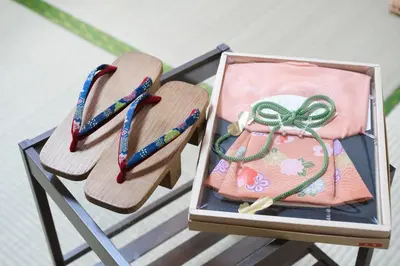two wooden chairs with a purse on a table at Housegreen201 in Tokyo