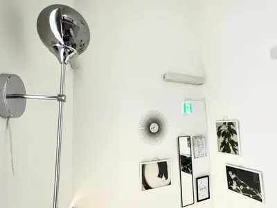 a room with a floor lamp and pictures on the wall at 1 stop to Shinjuku! Central NAKANO! up to 3ppl.cozy bright room. in Tokyo