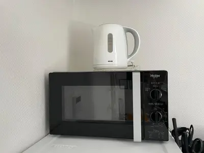 a coffee pot sitting on top of a microwave at 1 stop to Shinjuku! Central NAKANO! up to 3ppl.cozy bright room. in Tokyo