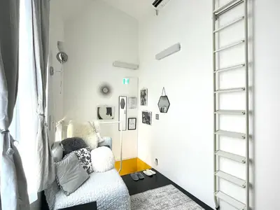 a living room with a white chair and a window at 1 stop to Shinjuku! Central NAKANO! up to 3ppl.cozy bright room. in Tokyo