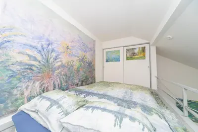 a bedroom with a colorful mural on the wall at Claude Monet Tokyo Shibuya Shinjyuku Wifi Free! in Tokyo