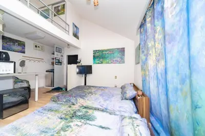 a bedroom with a bed with a blue bedspread at Claude Monet Tokyo Shibuya Shinjyuku Wifi Free! in Tokyo