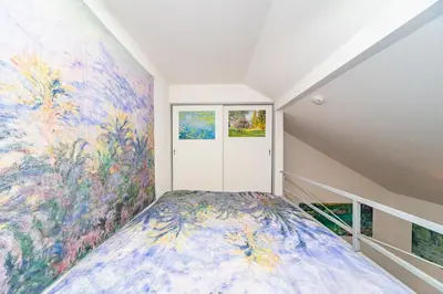 a bedroom with a large painting on the wall at Claude Monet Tokyo Shibuya Shinjyuku Wifi Free! in Tokyo