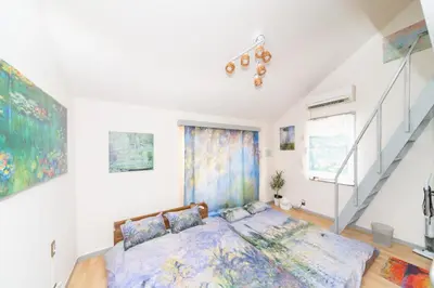 a bedroom with a bed and a staircase at Claude Monet Tokyo Shibuya Shinjyuku Wifi Free! in Tokyo