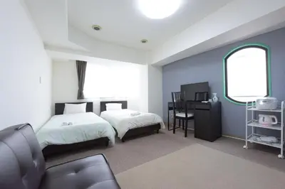a bedroom with two beds and a desk and a window at Hirojo Building 203,303,403,603,703 - Vacation STAY 15452 in Tokyo