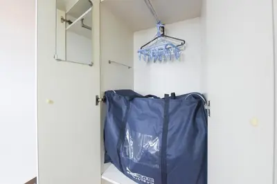 a closet with a blue bag hanging from a wall at Hirojo Building 203,303,403,603,703 - Vacation STAY 15451 in Tokyo