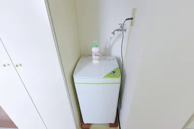 a washer and dryer in a corner of a bathroom at Hirojo Building 203,303,403,603,703 - Vacation STAY 15453 in Tokyo