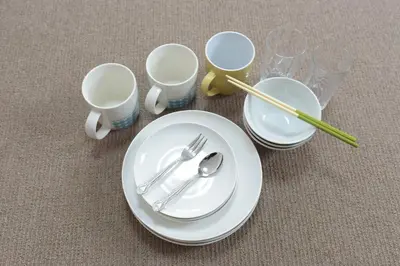 three white plates and chopsticks and cups on the floor at Hirojo Building 203,303,403,603,703 - Vacation STAY 15454 in Tokyo