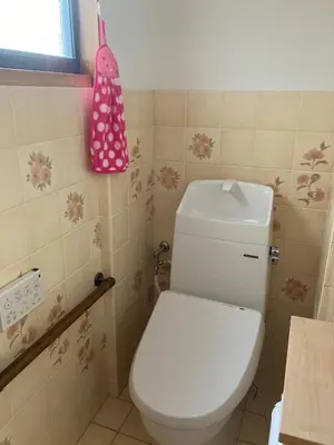 a bathroom with a toilet and a pink hat on the wall at Stay Dream Hotel - Vacation STAY 75122v in Tokyo