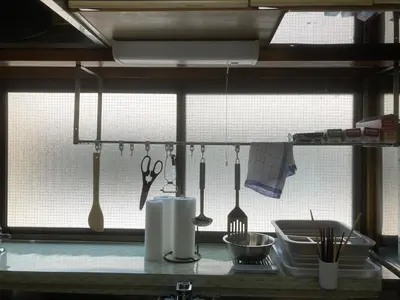 a kitchen counter with utensils hanging from a rack at Stay Dream Hotel - Vacation STAY 75122v in Tokyo