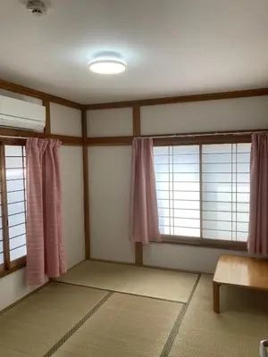 a room with two windows with pink curtains at Stay Dream Hotel - Vacation STAY 75122v in Tokyo