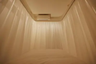 a room with a bed with a white curtain at SLEEPLAB THE STAY \u6e0b\u8c37 -\u7761\u7720\u7279\u5316\u578bHotel- in Tokyo