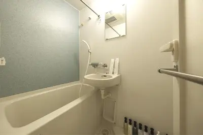 a white bathroom with a sink and a mirror at SLEEPLAB THE STAY \u6e0b\u8c37 -\u7761\u7720\u7279\u5316\u578bHotel- in Tokyo