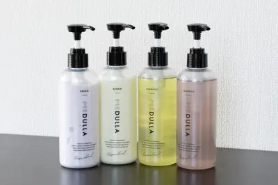 a group of four shampoo bottles sitting on a table at SLEEPLAB THE STAY \u6e0b\u8c37 -\u7761\u7720\u7279\u5316\u578bHotel- in Tokyo