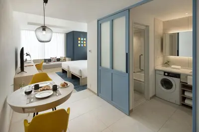 a kitchen and living room with a table and a bathroom at Hyatt House Tokyo Shibuya in Tokyo